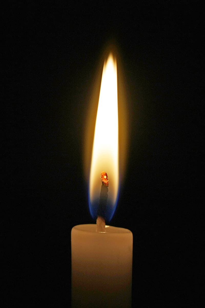 white candle in black background